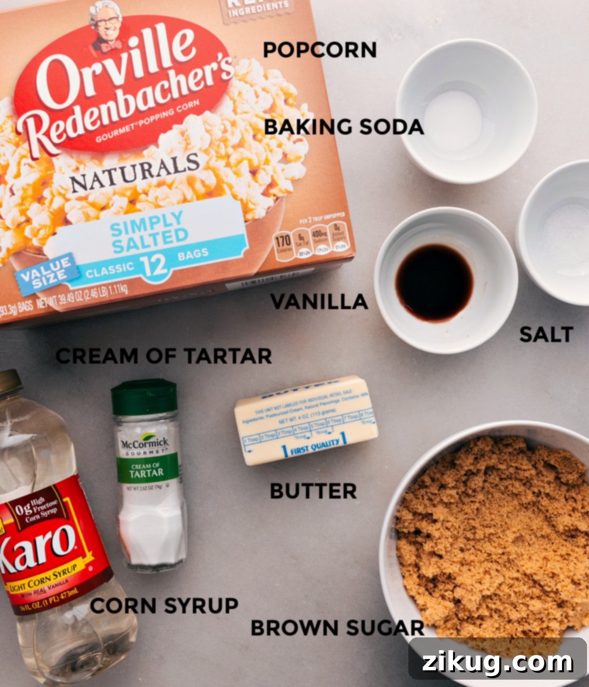 Essential Ingredients for the Best Caramel Corn Recipe All ingredients for the caramel corn recipe, including popcorn, butter, brown sugar, corn syrup, salt, baking soda, vanilla extract, and cream of tartar, neatly arranged on a counter.
