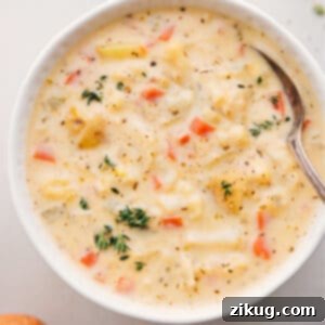 A beautifully presented bowl of creamy cauliflower soup, garnished with fresh herbs, ready to be enjoyed.