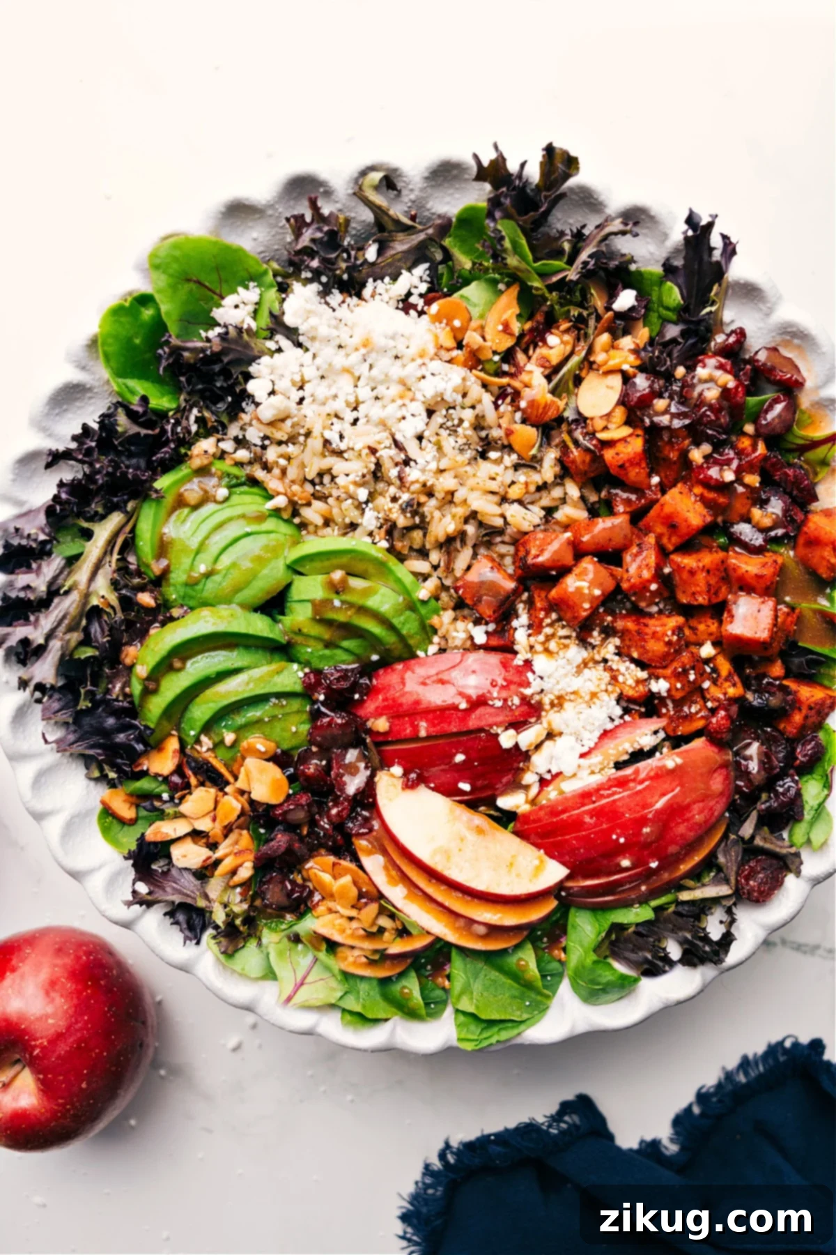 Fresh And Flavorful Fall Salad with Roasted Sweet Potatoes A beautifully presented Fall Salad in a rustic bowl, with roasted sweet potatoes, apples, wild rice, cranberries, and almonds visible, ready to be tossed with dressing.