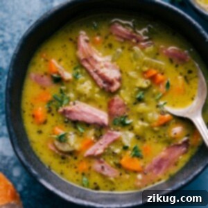 Hearty Split Pea Soup 3 A bowl of thick and creamy Split Pea Soup with Ham, garnished with fresh thyme.