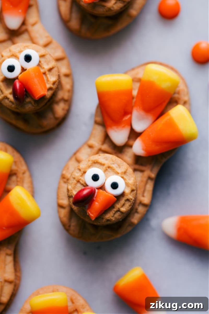 The Best Nutter Butter Turkey Cookies For Thanksgiving Close-up of a Nutter Butter Turkey fully assembled, showcasing the intricate details of its candy corn feathers, edible eyes, and red wattle.