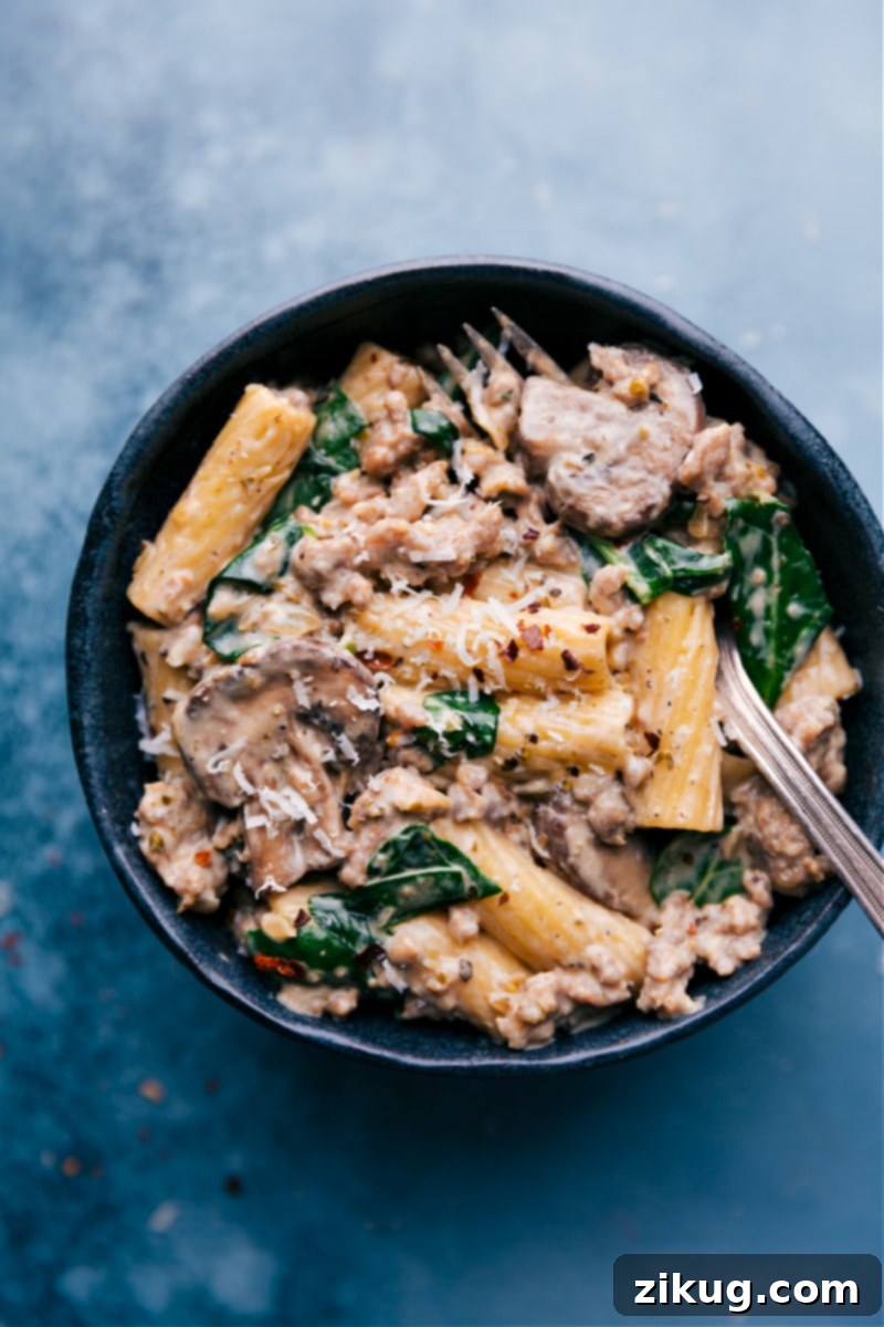 Individual servings of Creamy Sausage and Mushroom Rigatoni Overhead view of Creamy Sausage and Mushroom Rigatoni served in individual bowls, garnished with fresh Parmesan and parsley, ready to eat.