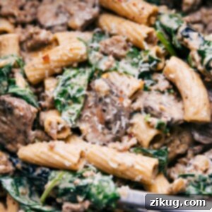A plate of Creamy Sausage and Mushroom Rigatoni garnished with fresh parsley.