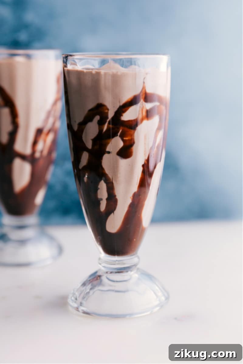 Close-up image of the Malted Milkshake ready to be served, topped with whipped cream and sprinkles