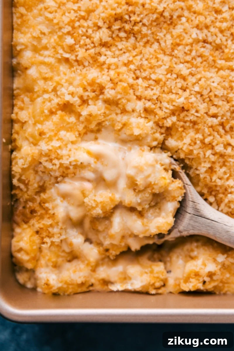 Experience the best Baked Mac and Cheese ever – unbelievably creamy, cheesy, and rich with a perfect blend of cheeses and the ultimate crispy topping. This simple and quick recipe from ChelseasMessyApron is your go-to for comfort food. #dinner #quick #easy #simple #comfortfood #familyfriendly #creamy #kidfriendly #baked #macandcheese Overhead image of Baked Mac and Cheese