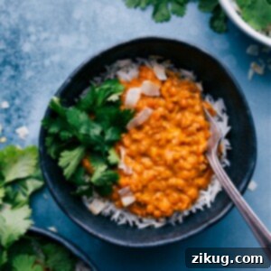 A close-up shot of the finished Daal, creamy and rich, with visible spices and lentils.