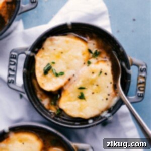 Classic French Onion Soup 3 A bowl of French Onion Soup with melted cheese and a spoon