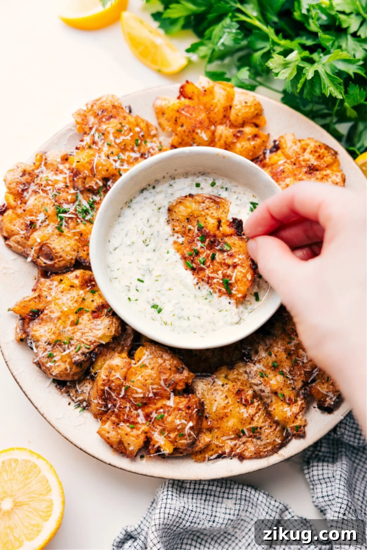 Crispy Smashed Potatoes Recipe with a side of homemade lemon-chive dipping sauce, ready to be enjoyed as a delightful side dish or appetizer.