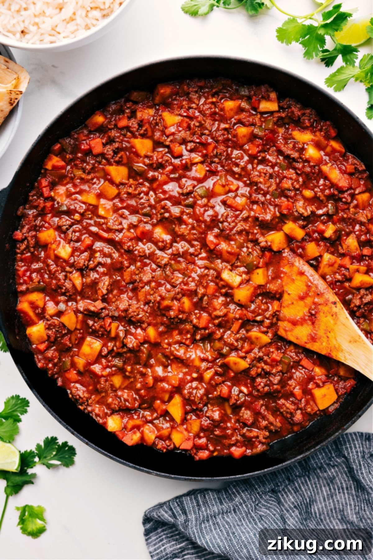 The Best Mexican Picadillo Recipe - Quick & Easy Ground Beef Dinner Mexican Picadillo in a skillet, ready to be served and enjoyed, garnished with fresh cilantro.