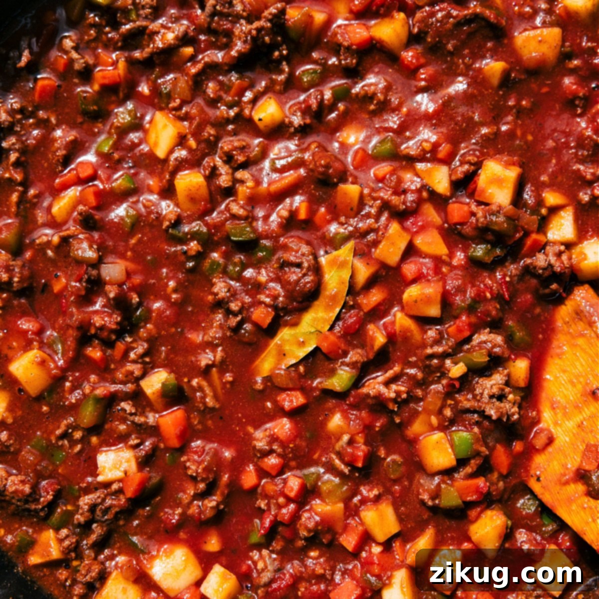 How To Make Mexican Picadillo - Simmering Perfection The Mexican Picadillo dish in a skillet simmering together, with steam rising, indicating its readiness to be enjoyed.