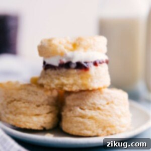 A stack of golden brown biscuits on a white plate, ready to be served.