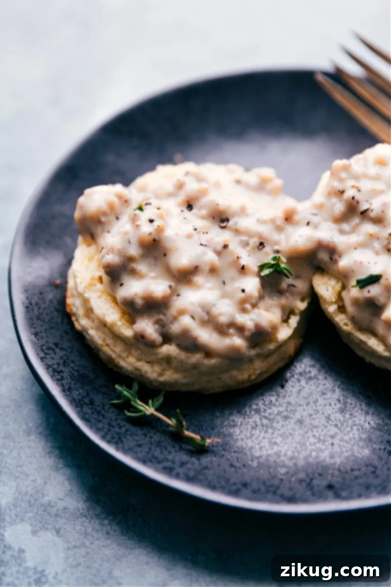 A plate of freshly prepared Biscuits and Gravy, showcasing the golden biscuits and a generous pour of creamy sausage gravy.