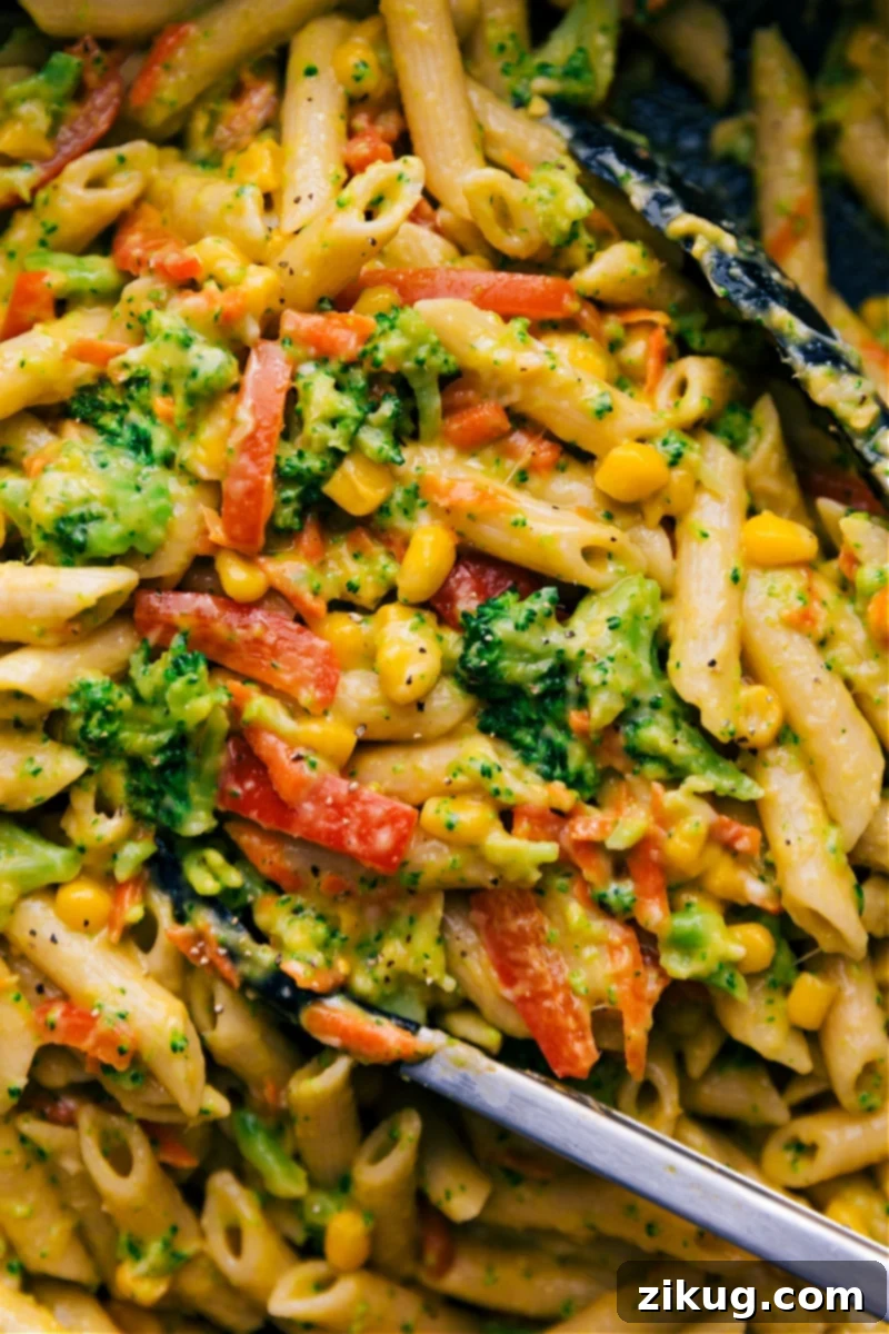 Overhead image of Vegetable Pasta, showcasing a vibrant mix of broccoli, corn, and red peppers in a creamy sauce with penne pasta.