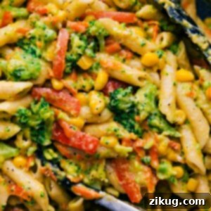 A close-up shot of the finished creamy vegetable pasta, showing its rich texture and vibrant ingredients.
