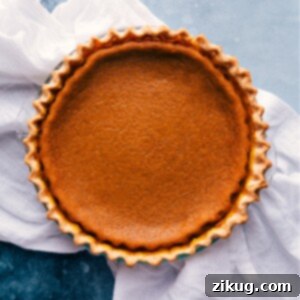 Beautifully baked pumpkin pie with whipped cream on top, ready to be served for Thanksgiving.