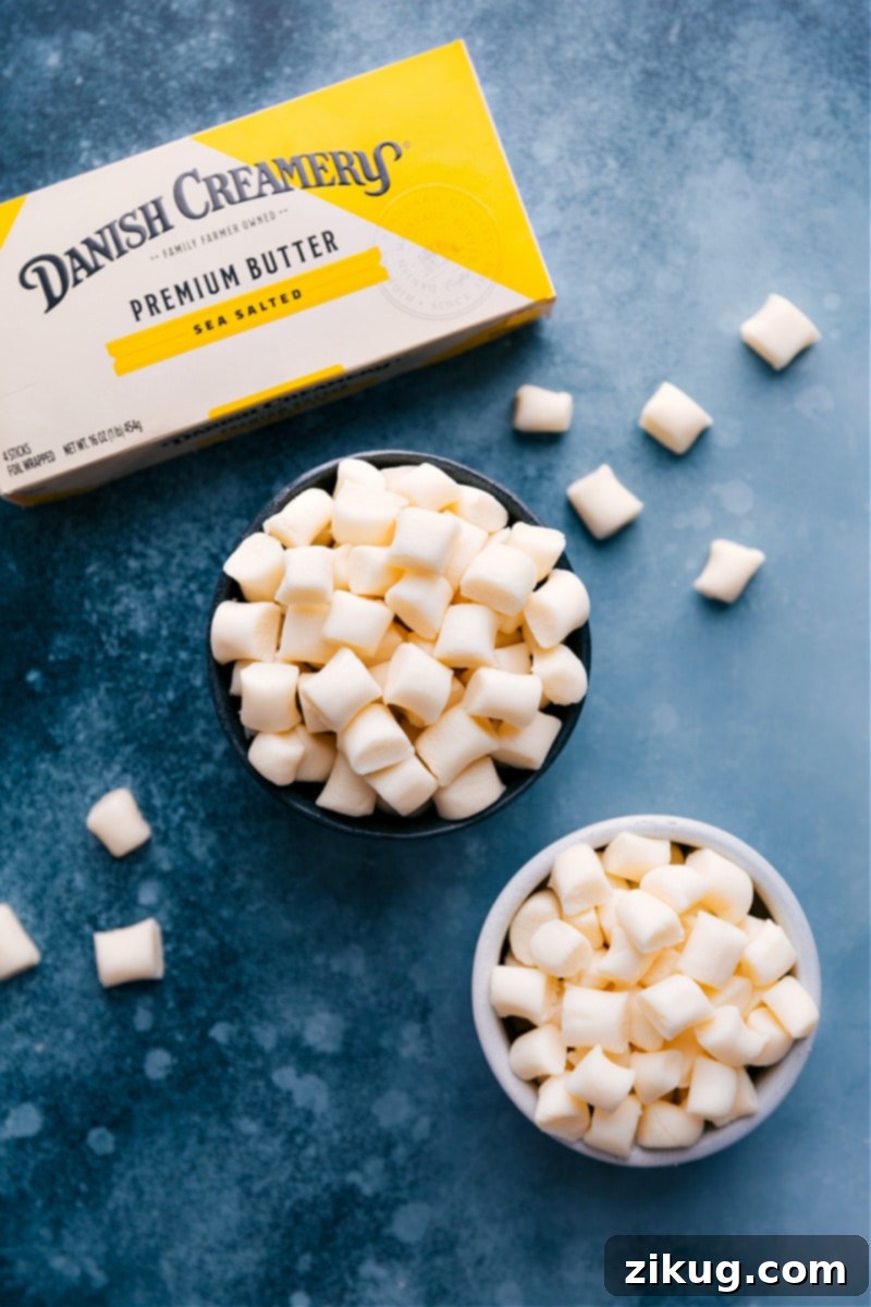 This Butter Mints recipe delivers sweet and pepperminty deliciousness. Making candy from scratch can seem daunting, but these mints are so simple to whip together – no candy thermometer needed. Try this homemade version! #buttermints #candy #homemade #easy #mints #treat #party #special Bowls of Butter Mints with a container of butter nearby