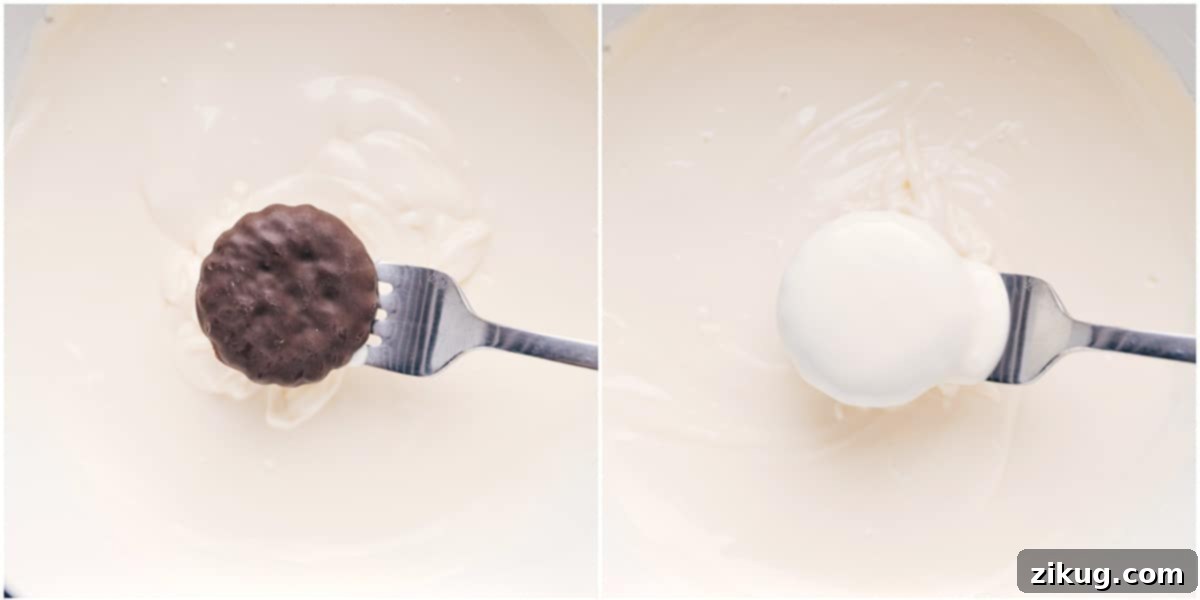 A mint cookie being carefully dipped into a bowl of smooth, melted white chocolate, illustrating a key step in making these easy peppermint cookies.