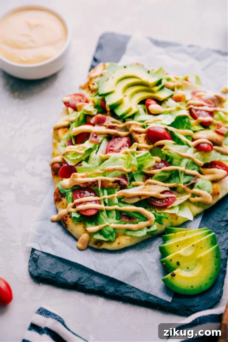 Chipotle Chicken Flatbread - Quick & Easy Dinner Recipe Delicious Chipotle Chicken Flatbread on a wooden board, garnished with fresh ingredients.