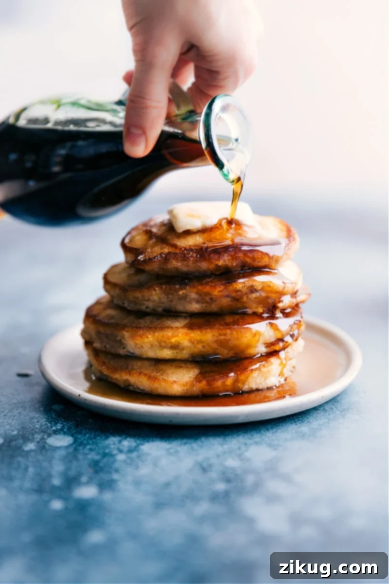 Pancake Syrup -- you'll be amazed how quick and easy it is! Plus, when you make it yourself, you don't have to worry about any artificial ingredients or corn syrup. Recipe via ChelseasMessyApron #dessert #best #quick #easy #simple #breakfast #sauce #brunch #pancake #syrup Overhead image of homemade Pancake Syrup being poured generously over a stack of golden pancakes