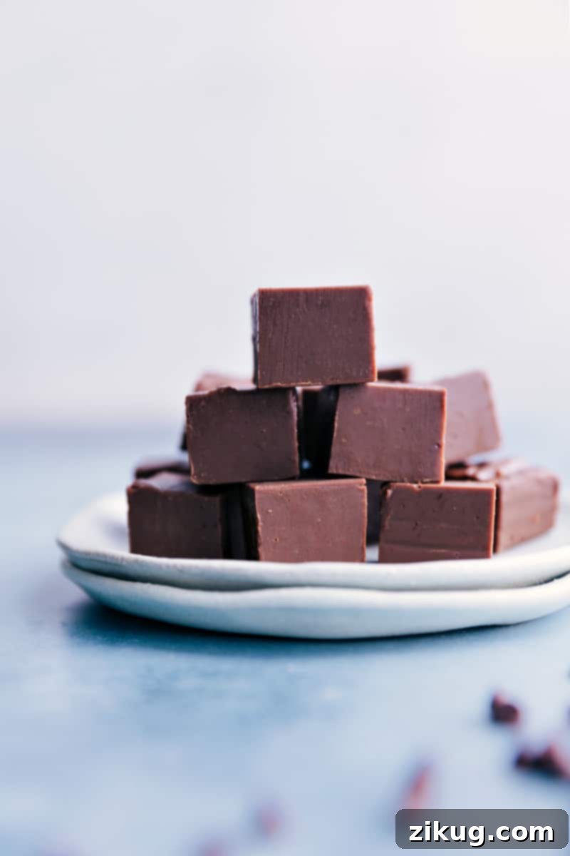 The easiest, foolproof homemade chocolate Fudge Recipe! No special equipment or candy thermometer needed to make this quick and delicious candy. Recipe via ChelseasMessyApron.com #fudge #candy #chocolate #easy #fast #treat A plate filled with Fudge
