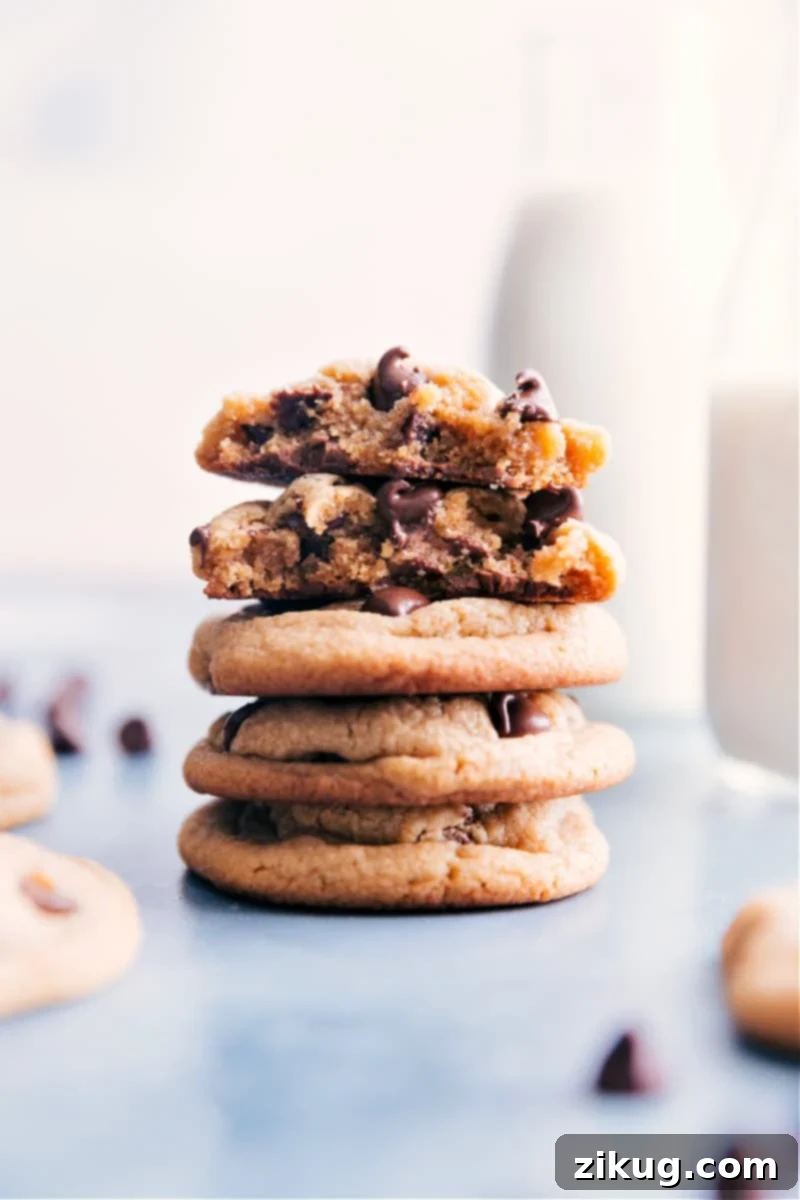 Thick, Sweet, Soft & Chewy Peanut Butter Chocolate Chip Cookies - The Perfect Texture with Luscious Center & Crisp Edges. Loaded with Chocolate! Image of the stacked Peanut Butter Chocolate Chip Cookies showcasing their thick, soft, and chewy texture with melted chocolate chips