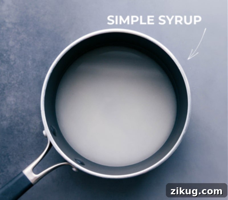 Simple syrup being prepared in a small pot on the stove, a key ingredient for homemade drinks.