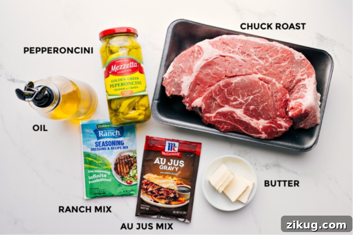 Essential Ingredients For The Best Mississippi Pot Roast Recipe Key ingredients prepped and laid out for an easy Crockpot Mississippi Pot Roast assembly: pepperoncini, a boneless beef chuck roast, a packet of ranch seasoning mix, an au jus gravy mix, cubes of unsalted butter, and olive oil.