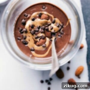 Chocolate almond overnight oats in a bowl, generously topped with almonds and chocolate chips.