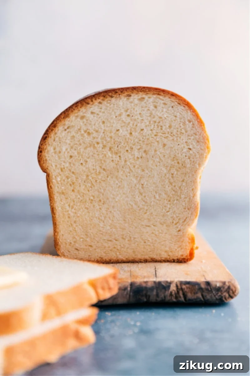 This is our go-to, favorite White Bread recipe made with only six common ingredients. Instead of making a grocery run first, you may already have everything you need! Recipe via ChelseasMessyApron #homemade #best #quick #easy #dough #white #bread A perfectly sliced loaf of homemade white bread showing its soft, airy interior.