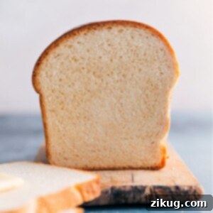 A freshly baked loaf of homemade white bread, golden brown and inviting.