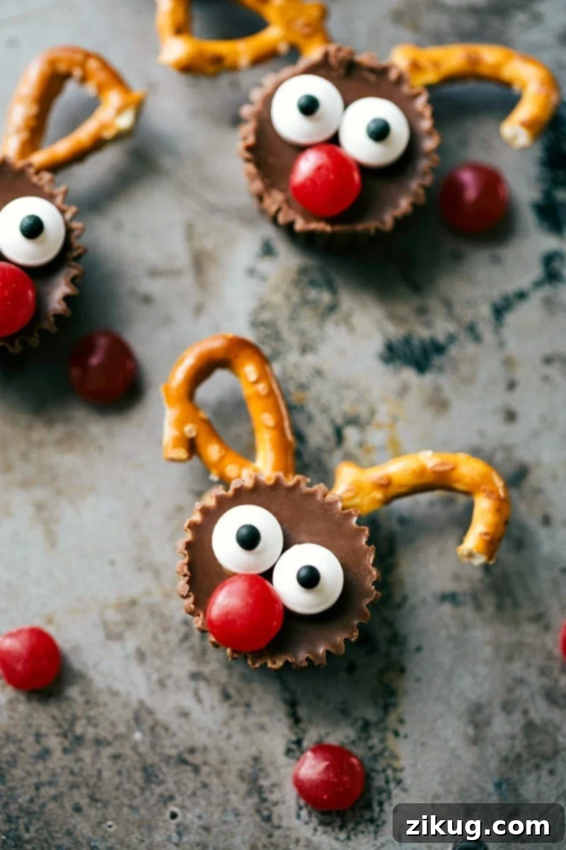 Magical Reindeer Morsels 2 Adorable mini reindeer treats made from Reese's cups, pretzels, candy eyes, and red M&Ms, arranged on a festive platter.