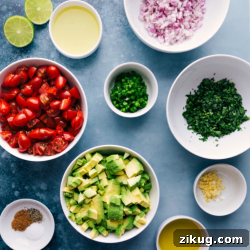 Close-up shot of fresh ingredients laid out, including ripe avocados, red onions, cherry tomatoes, cilantro, and jalapeños, ready for the avocado salsa