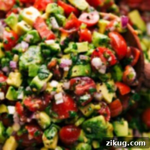 Finished bowl of vibrant Avocado Salsa with a side of tortilla chips