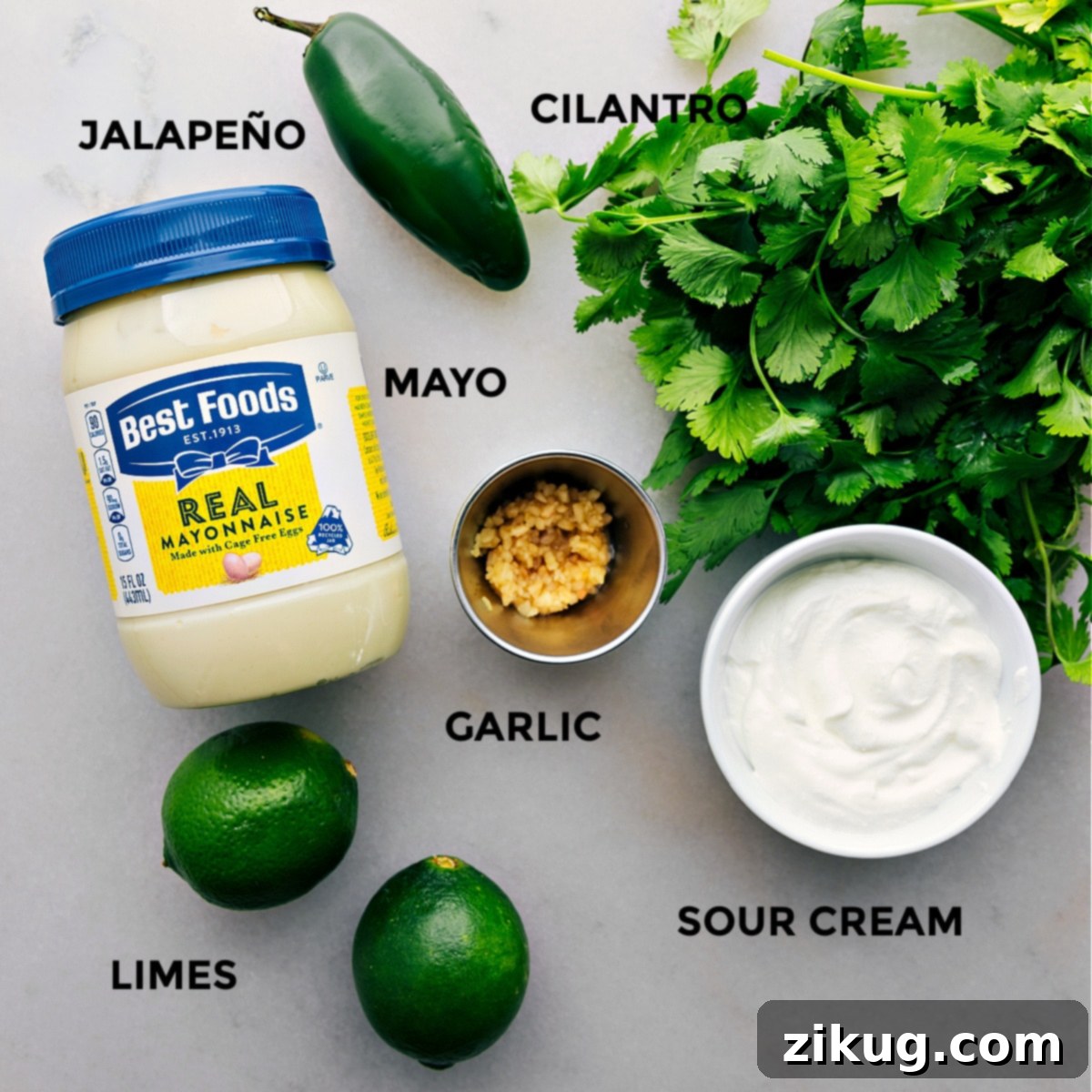 All fresh ingredients for Cilantro Lime Sauce laid out on a cutting board, ready for preparation.