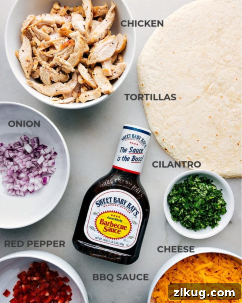 Essential ingredients for crafting these delicious and easy BBQ Chicken Wraps. A flat lay image showcasing all the fresh ingredients for BBQ Chicken Wraps: shredded chicken, BBQ sauce, cilantro, red onion, red bell pepper, and sharp Cheddar cheese.