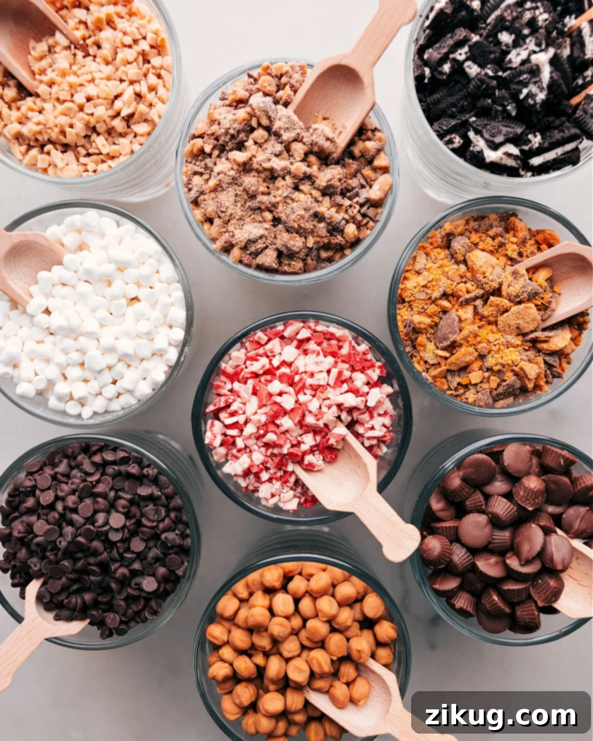 Decadent Choices: Hot Chocolate Bar Toppings Displayed Elegantly Array of toppings in small glass bowls for a hot chocolate bar, including marshmallows, chocolate chips, and sprinkles.