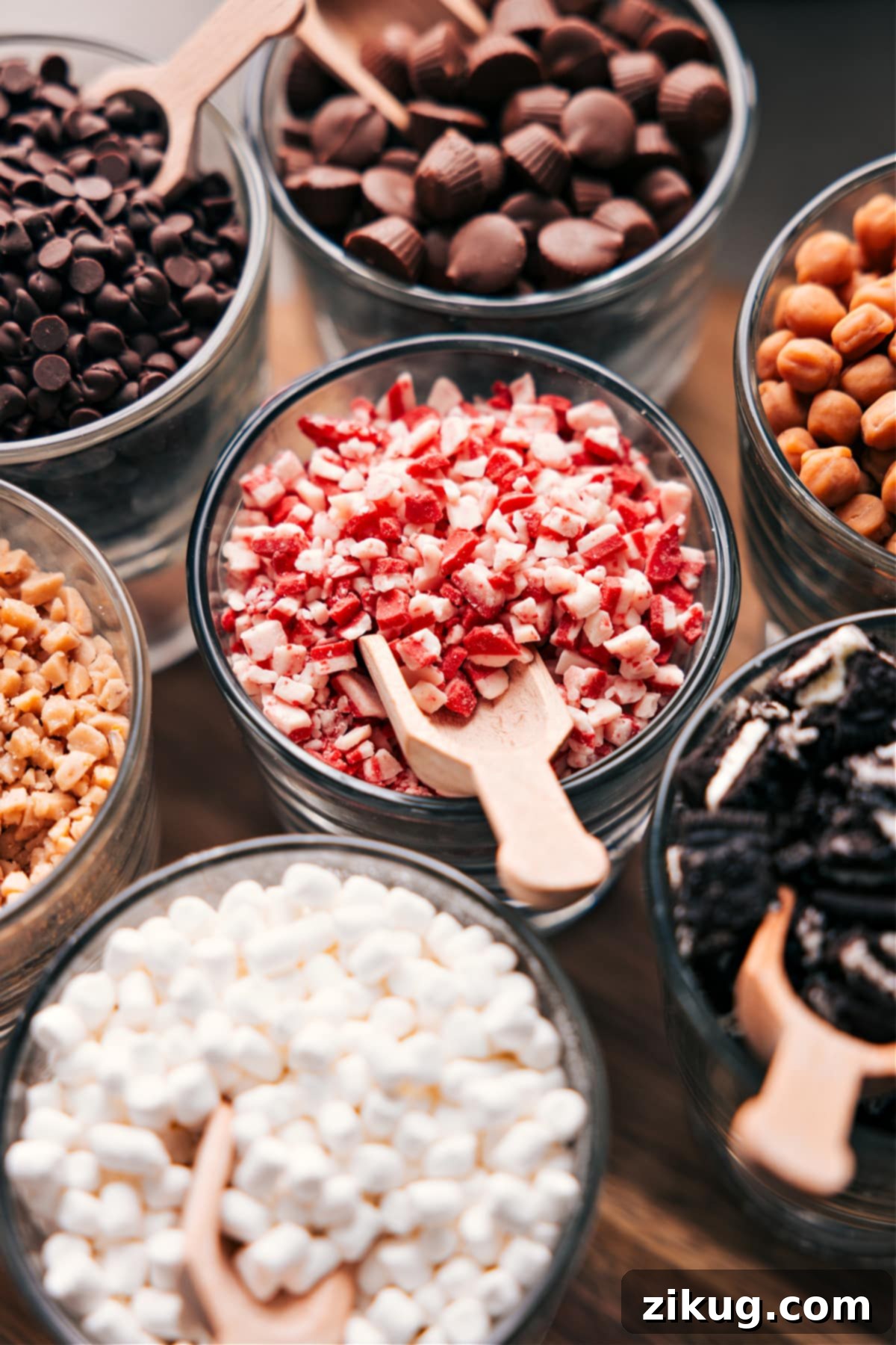 Delicious Details: An Up-Close Exploration of Hot Chocolate Bar Delights Diverse hot chocolate toppings in glass bowls, each with a scoop nestled inside.