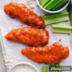 Crispy Baked Buffalo Chicken Tenders served in a basket with ranch and celery