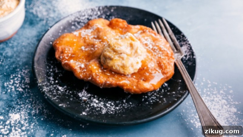 Side view of a fluffy, golden Utah Scone, showcasing its perfect texture