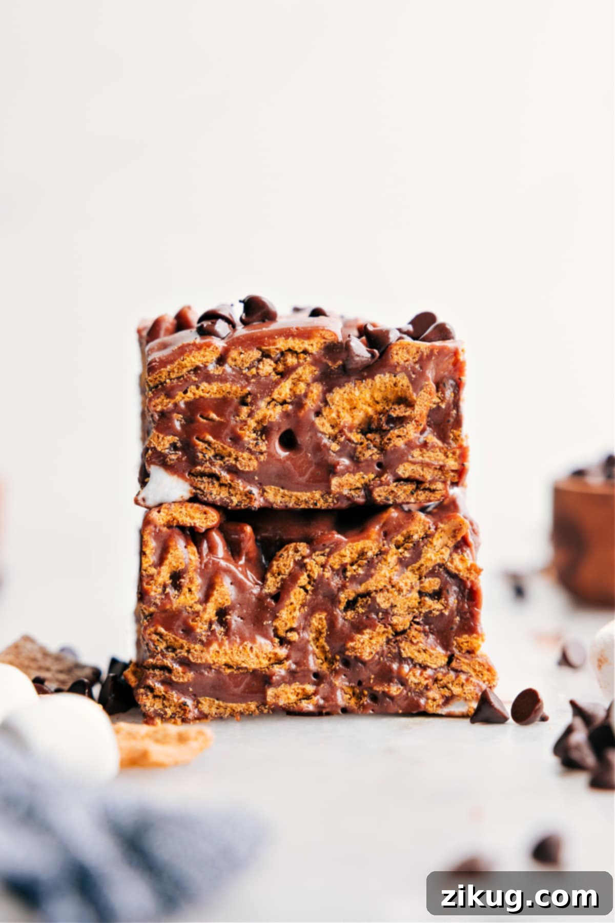 Irresistible No-Bake S'mores Cereal Bars: Your New Favorite Dessert Delicious S'mores Cereal Bars piled high, showcasing their gooey marshmallow and chocolate layers and crunchy graham cereal texture.