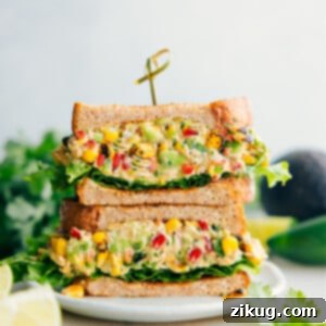 Mexican Street Corn Chicken Salad sandwiched between bread and lettuce.
