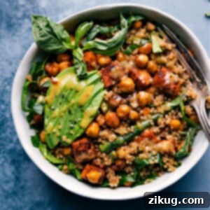 The ultimate Nourish Bowl featuring roasted sweet potatoes, green beans, chickpeas, quinoa, spinach, avocado, basil, and hot honey mustard sauce.