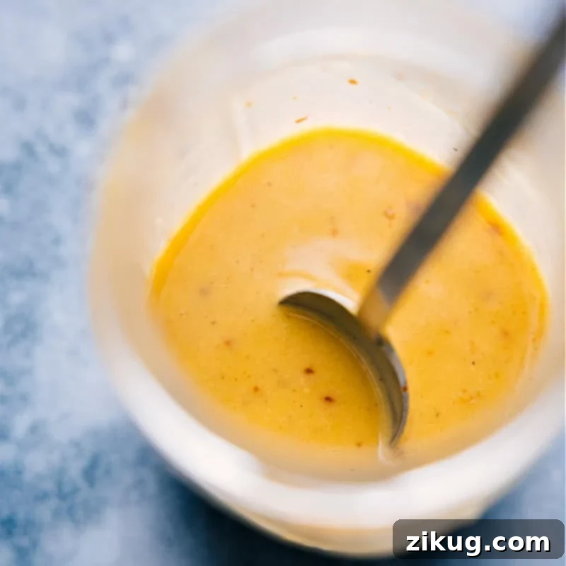 Close-up overhead shot of the delicious hot honey mustard sauce in a bowl, showing its creamy texture