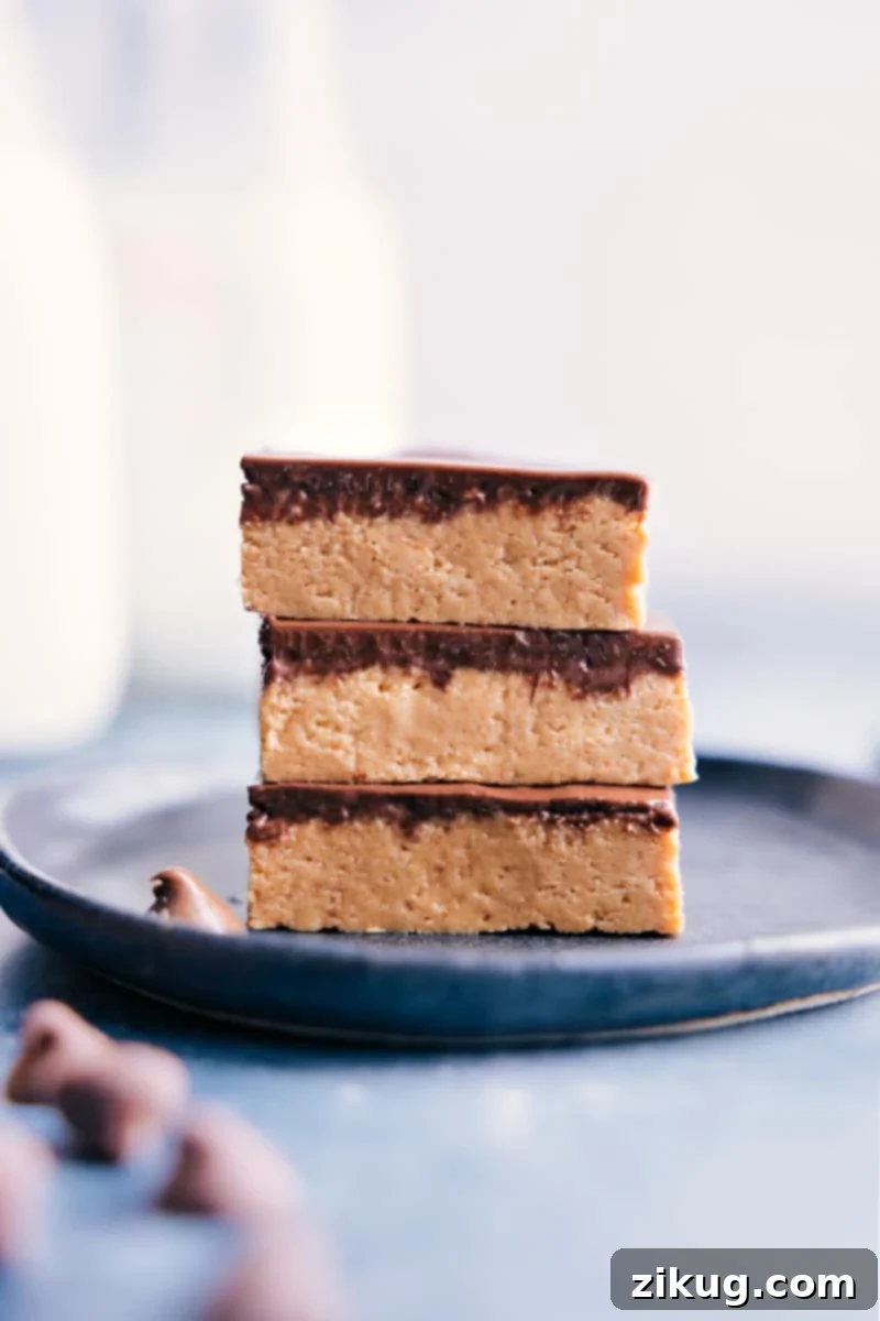 Irresistible No-Bake Peanut Butter Bars with Chocolate Topping - Quick & Easy Recipe Stacked image of rich, no-bake peanut butter bars with smooth chocolate topping, ready to eat.