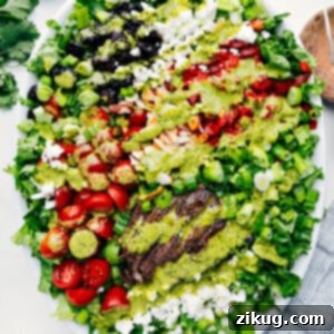 Finished grilled steak salad drizzled with dressing.