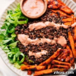 Delicious Burger Bowl served with crispy fries, ground beef, fresh toppings, and a generous drizzle of homemade sauce.