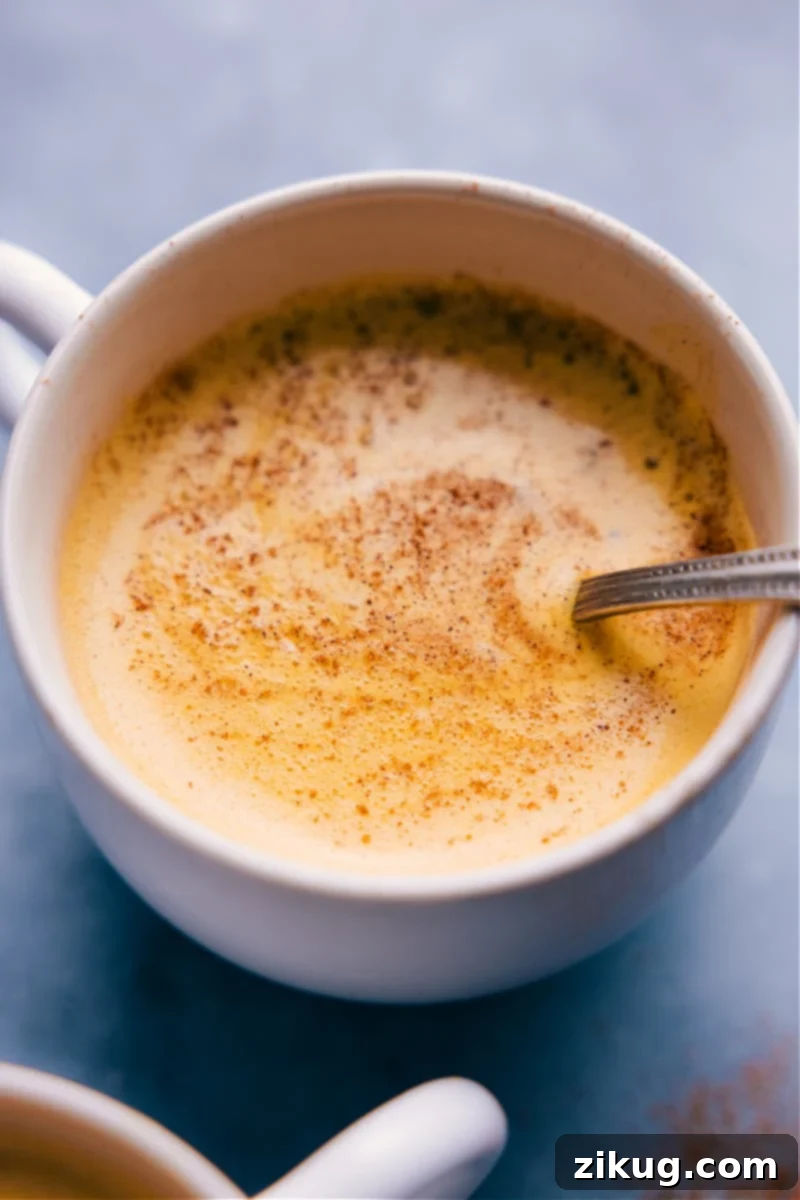 Overhead image of Golden Milk in a mug, garnished with a sprinkle of cinnamon, ready to be enjoyed.