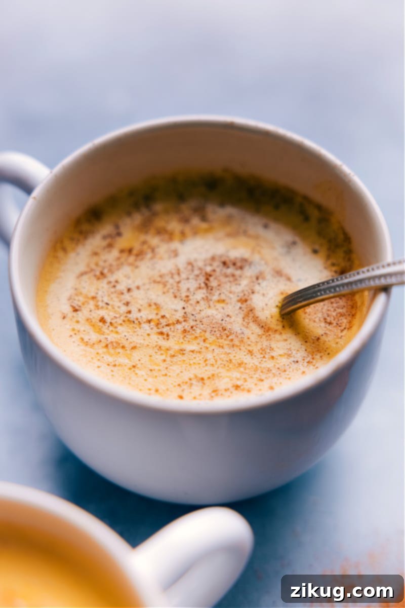 A close-up image of a glass of Golden Milk, ready to be served, showing its vibrant yellow color and smooth texture.