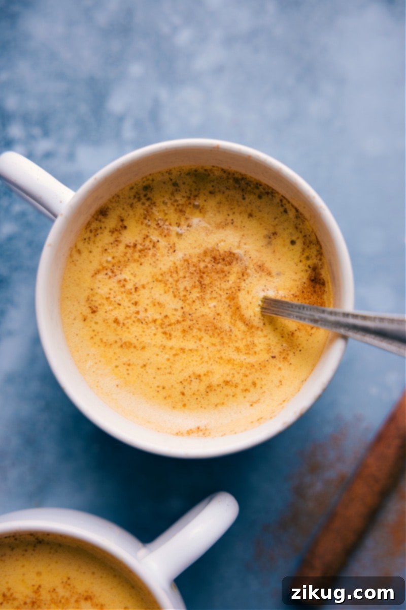 An up-close, overhead image of Golden Milk in a cup, showcasing its rich golden color and smooth consistency.
