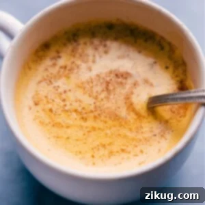 A finished cup of Golden Milk, a nourishing turmeric latte.